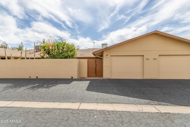 view of front of house with fence and a garage