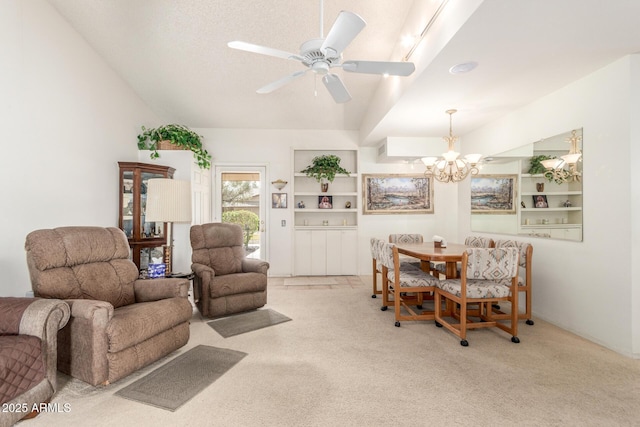 carpeted living room with built in features, ceiling fan with notable chandelier, and lofted ceiling