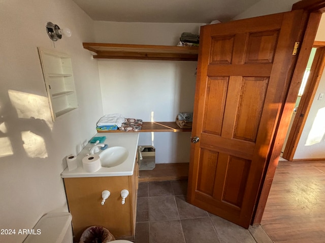 bathroom featuring tile flooring and vanity