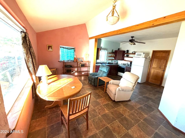 tiled dining room featuring ceiling fan and vaulted ceiling with beams