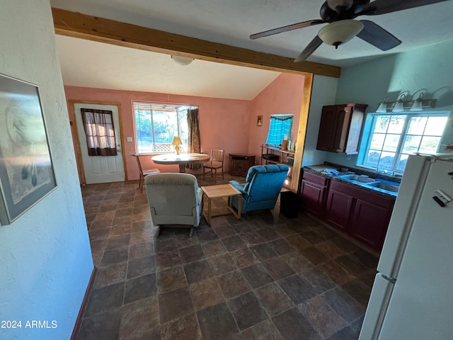 interior space featuring lofted ceiling with beams, sink, dark tile floors, and ceiling fan