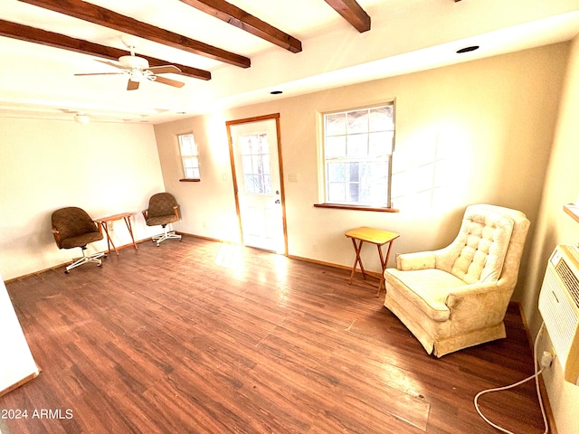 living area with a wealth of natural light, beamed ceiling, ceiling fan, and hardwood / wood-style flooring