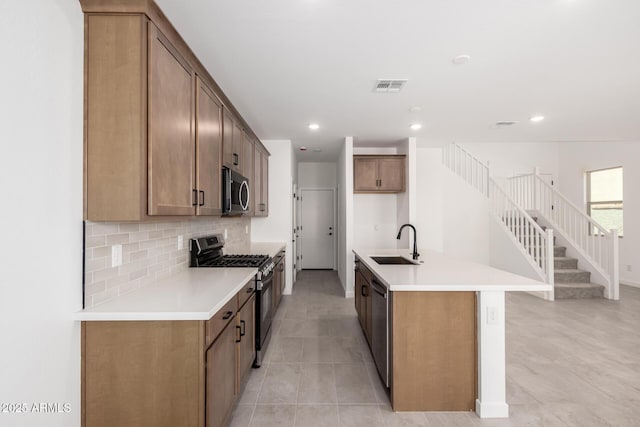 kitchen with recessed lighting, visible vents, backsplash, appliances with stainless steel finishes, and a sink