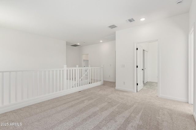 carpeted spare room with recessed lighting, visible vents, and baseboards