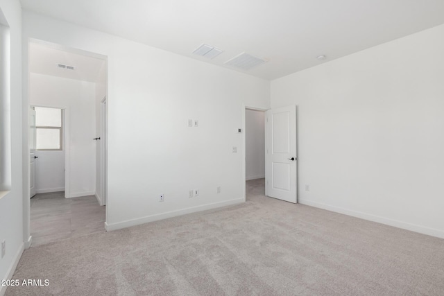 unfurnished bedroom featuring carpet flooring, visible vents, and baseboards