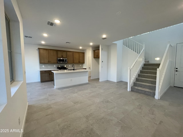 unfurnished living room with recessed lighting, visible vents, baseboards, and stairs