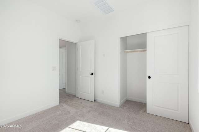 unfurnished bedroom featuring carpet floors, a closet, visible vents, and baseboards