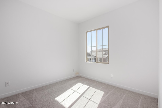 empty room with light carpet and baseboards