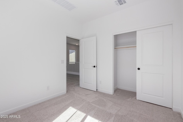 unfurnished bedroom featuring a closet, carpet, visible vents, and baseboards