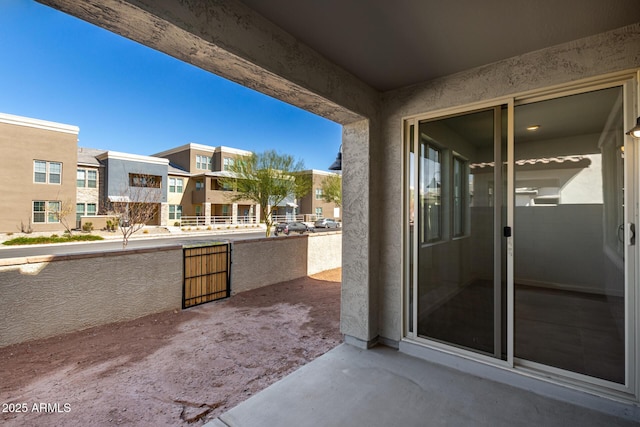 view of patio featuring a balcony and a residential view