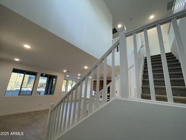 stairs featuring baseboards, visible vents, and recessed lighting