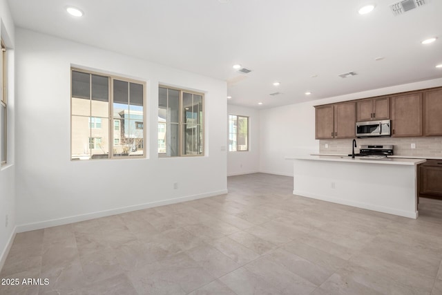 kitchen with visible vents, appliances with stainless steel finishes, light countertops, backsplash, and recessed lighting