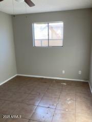104 N Casa Grande Ave, Casa Grande, AZ 85122 - unfurnished room featuring tile patterned flooring, baseboards, and a ceiling fan