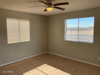 104 N Casa Grande Ave, Casa Grande, AZ 85122 - tiled empty room with baseboards and ceiling fan