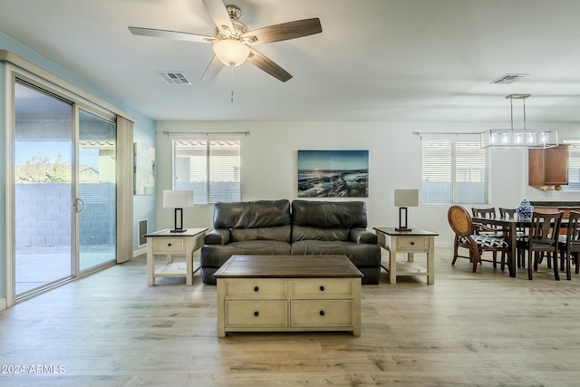 living room featuring ceiling fan and light hardwood / wood-style flooring