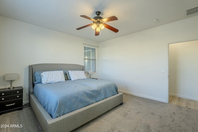 bedroom with ceiling fan and light colored carpet