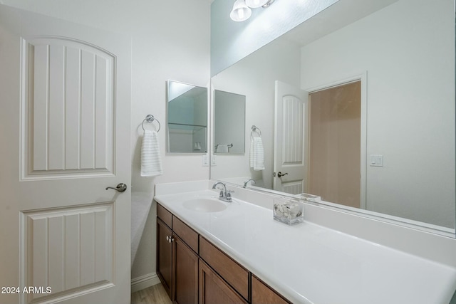 bathroom with hardwood / wood-style floors and vanity