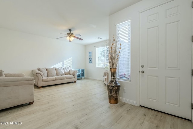 living room featuring ceiling fan and light hardwood / wood-style flooring