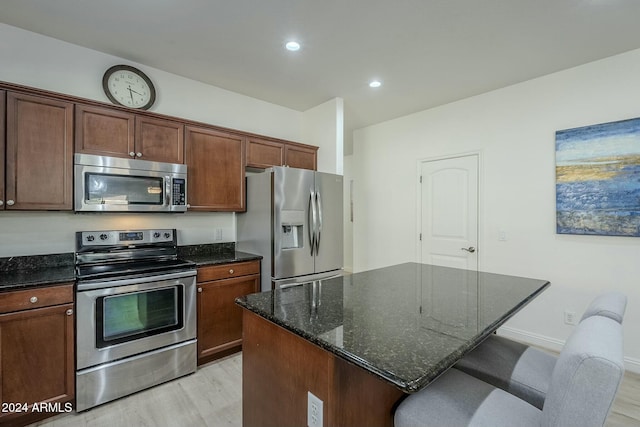 kitchen featuring a center island, light hardwood / wood-style flooring, and appliances with stainless steel finishes