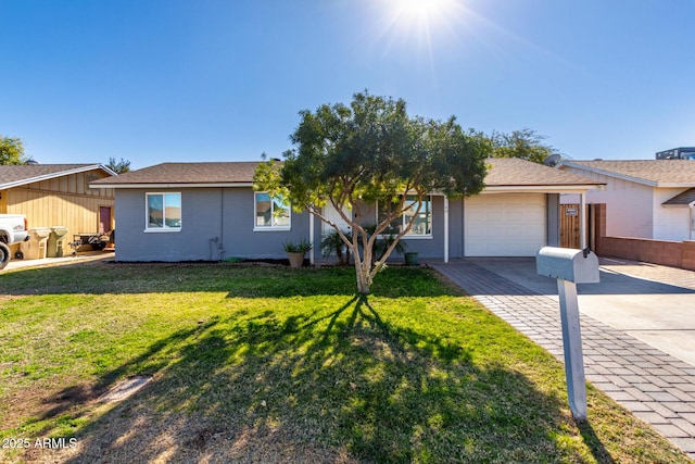 single story home featuring a front lawn and a garage