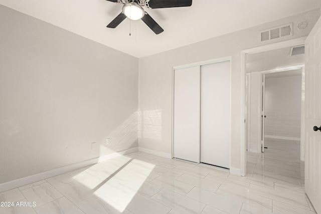 unfurnished bedroom with a closet and ceiling fan