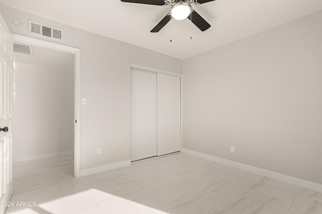 unfurnished bedroom with a closet and ceiling fan