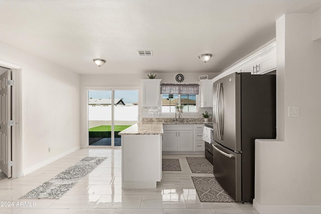 kitchen with white cabinetry, sink, light stone countertops, backsplash, and appliances with stainless steel finishes