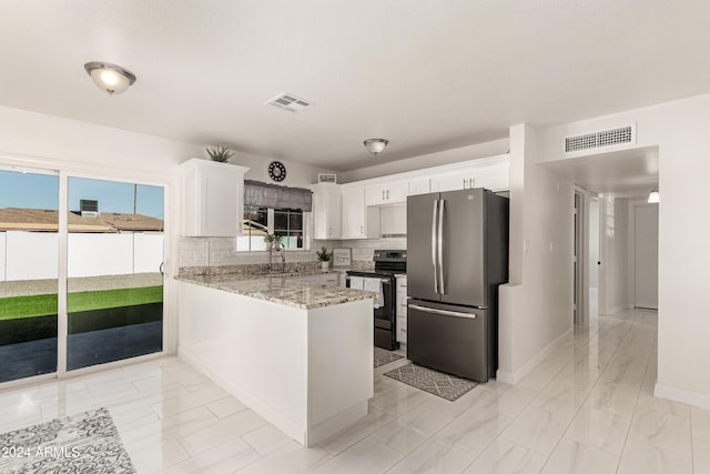 kitchen with kitchen peninsula, backsplash, light stone counters, stainless steel appliances, and white cabinetry