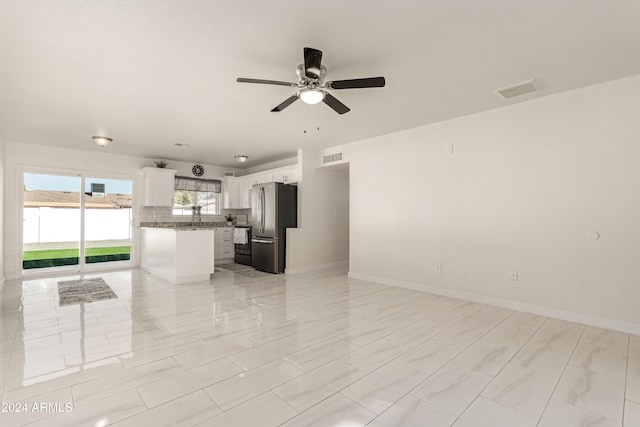 unfurnished living room with ceiling fan