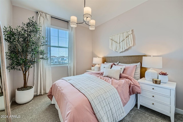 carpeted bedroom featuring a notable chandelier