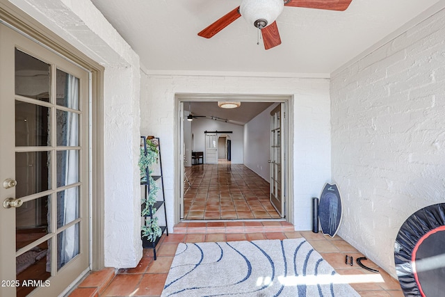 view of exterior entry featuring ceiling fan