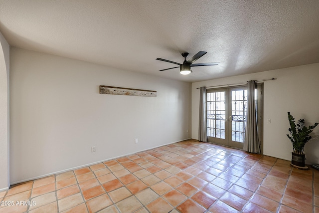 spare room with french doors, ceiling fan, a textured ceiling, and light tile patterned floors