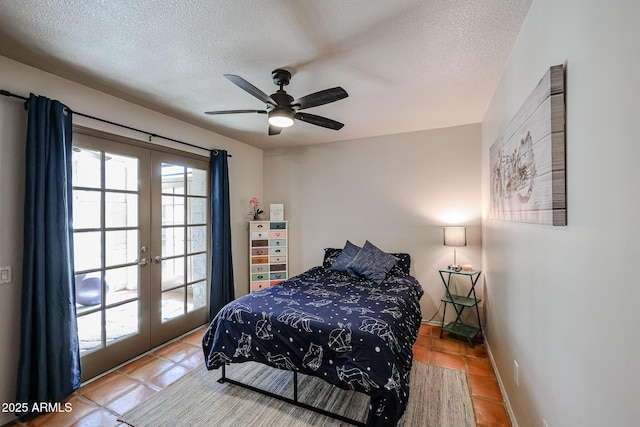 tiled bedroom featuring ceiling fan, a textured ceiling, and french doors