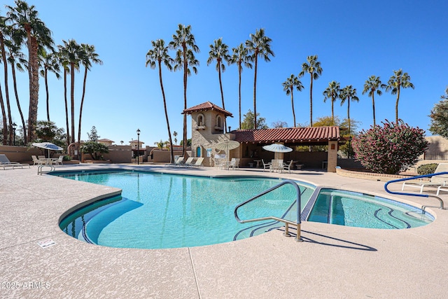 view of swimming pool with a fireplace and a patio area