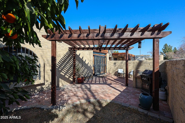 view of patio / terrace featuring area for grilling and a pergola