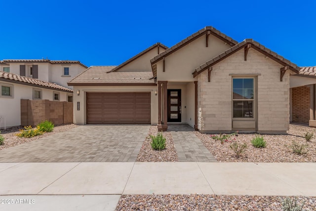 19354 S 212th Pl, Queen Creek, AZ 85142 - view of front of home featuring a garage, decorative driveway, a tiled roof, and stucco siding