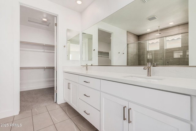 19354 S 212th Pl, Queen Creek, AZ 85142 - full bathroom with a stall shower, a walk in closet, double vanity, tile patterned flooring, and recessed lighting