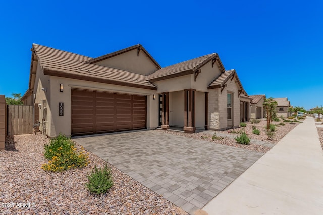 19354 S 212th Pl, Queen Creek, AZ 85142 - view of front of house featuring a garage, decorative driveway, stucco siding, a gate, and a tiled roof