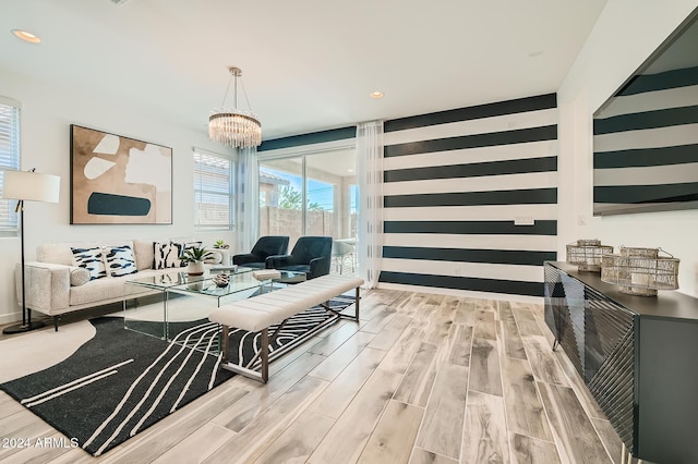 living room featuring a chandelier and light hardwood / wood-style floors