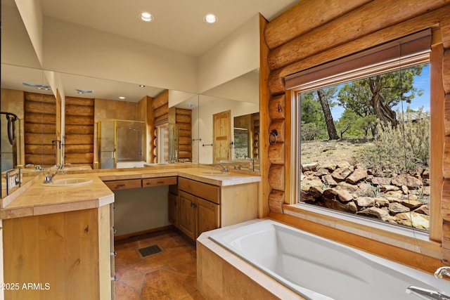 full bathroom featuring a sink, a shower stall, a bath, and log walls