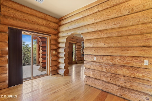 interior space featuring hardwood / wood-style floors and log walls