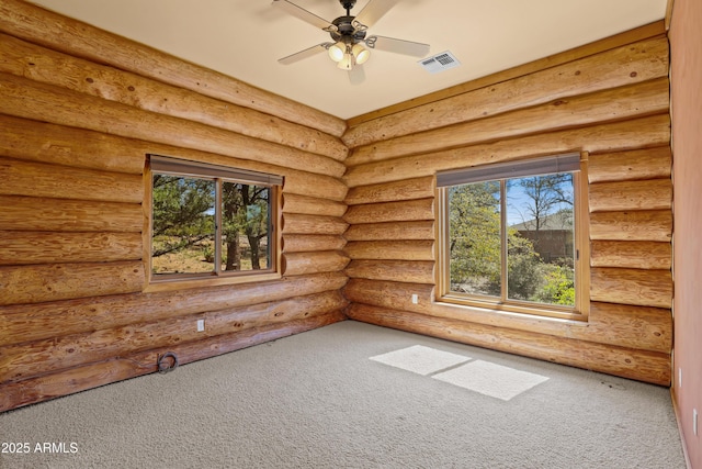 unfurnished room with ceiling fan, rustic walls, visible vents, and carpet floors