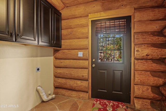 washroom with cabinet space, rustic walls, and hookup for an electric dryer