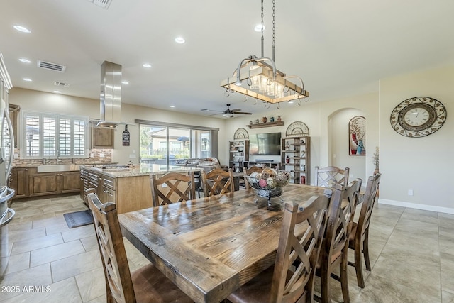 dining space with sink and ceiling fan