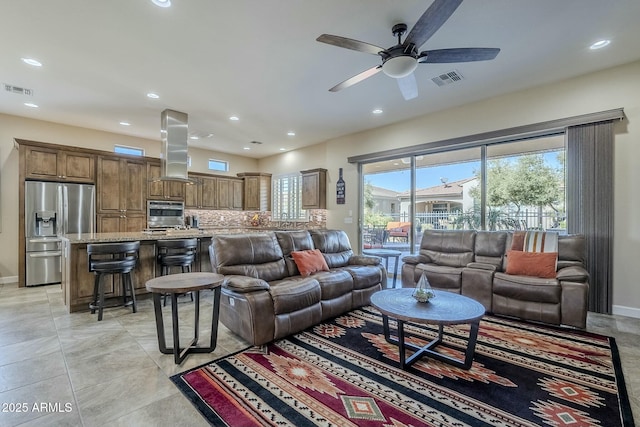 tiled living room featuring ceiling fan