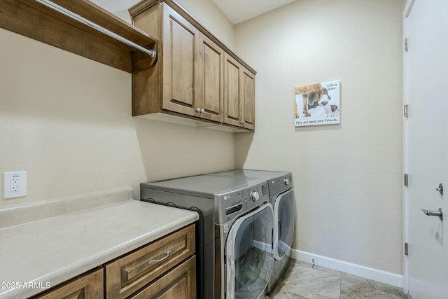 laundry room with cabinets and separate washer and dryer