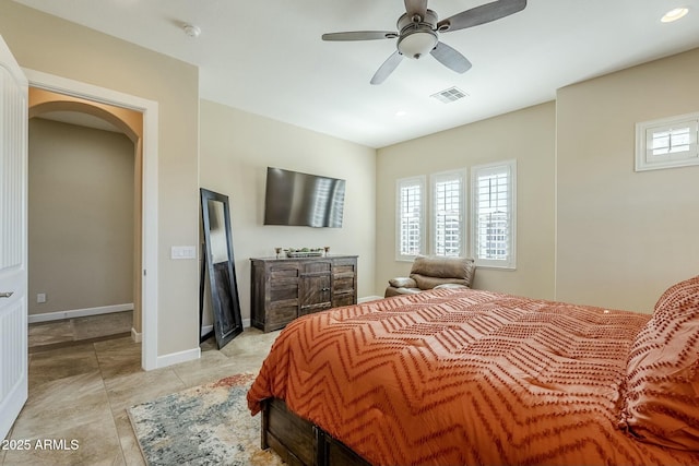 tiled bedroom featuring ceiling fan