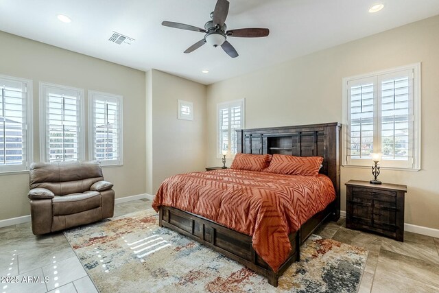 bedroom featuring multiple windows and ceiling fan