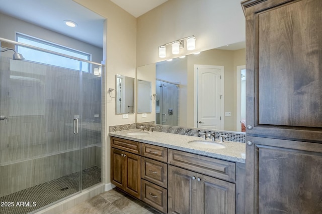 bathroom featuring vanity and a shower with shower door