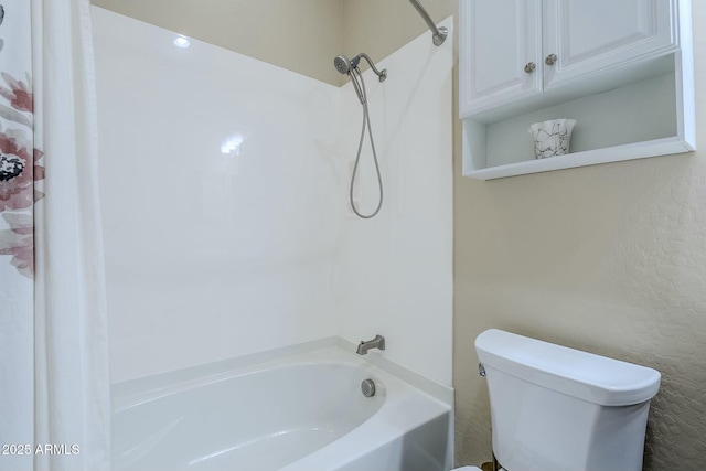 bathroom featuring bathtub / shower combination and toilet